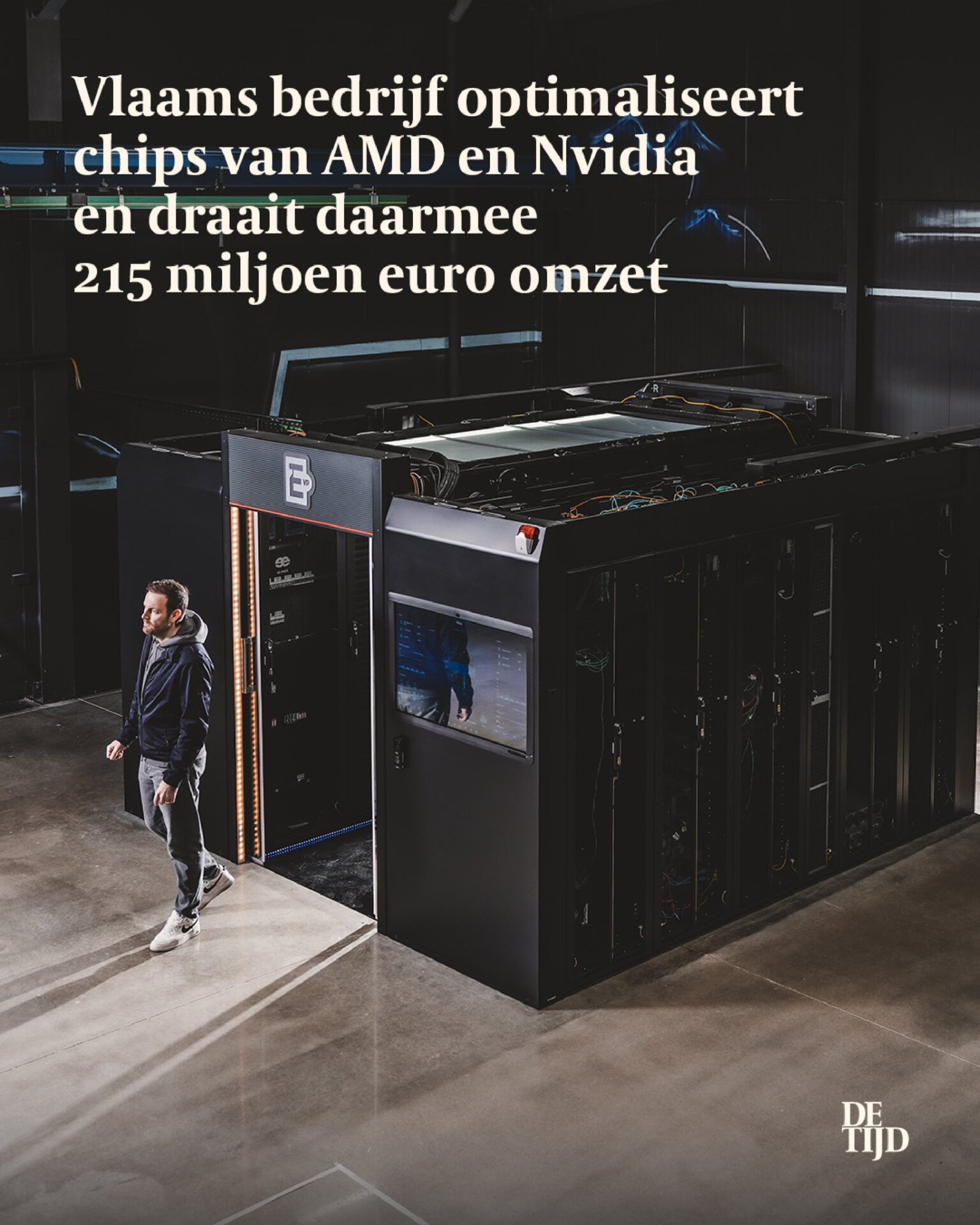 ElioVP founder holding De Tijd newspaper front page feature inside a modular data center server aisle