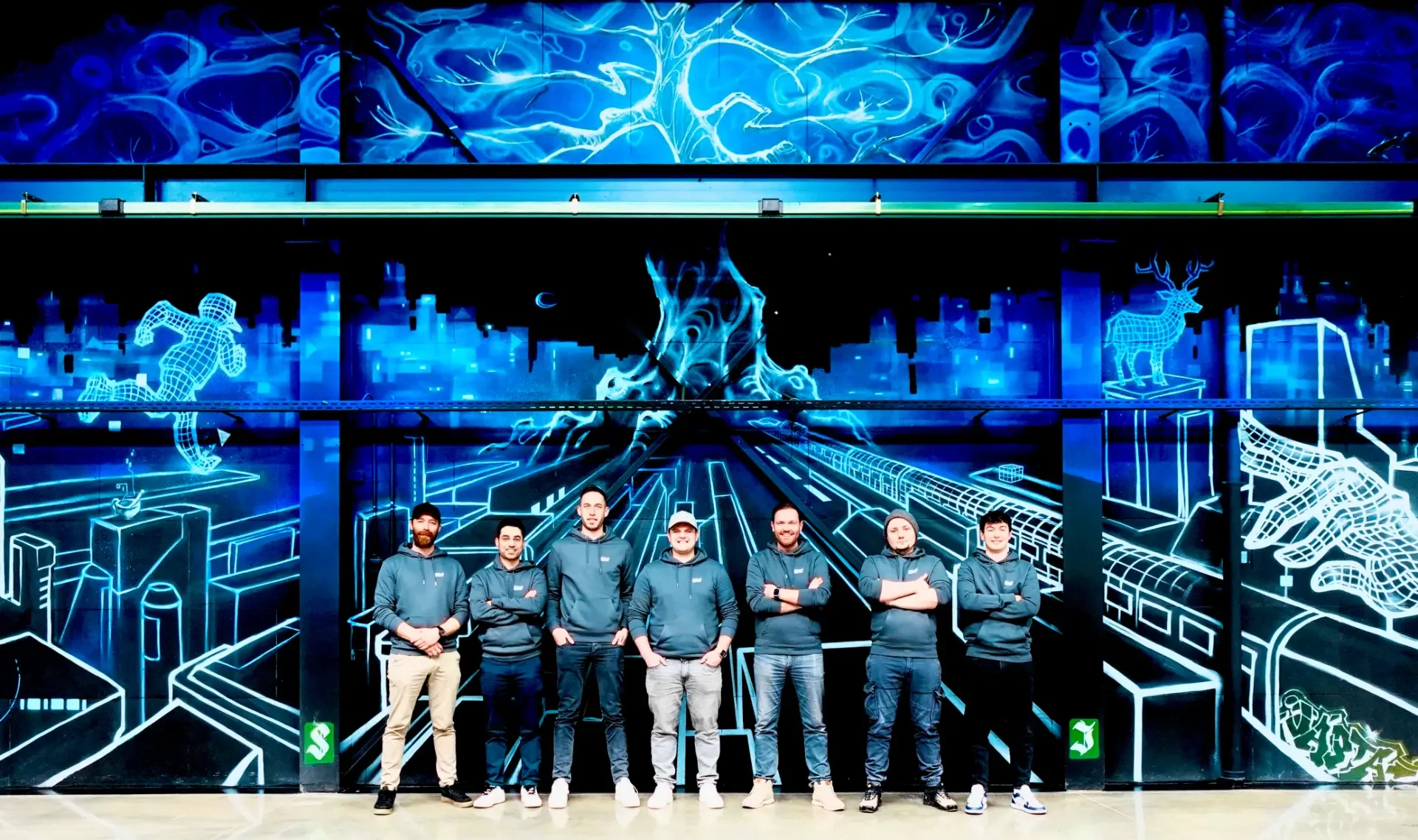 ElioVP team in front of a technical mural